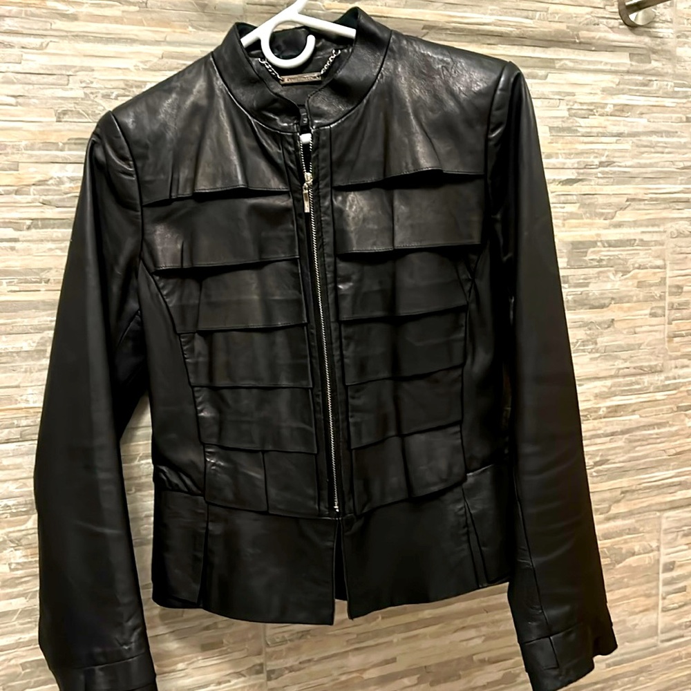 Black leather jacket. Lots of detail and extremely flattering.